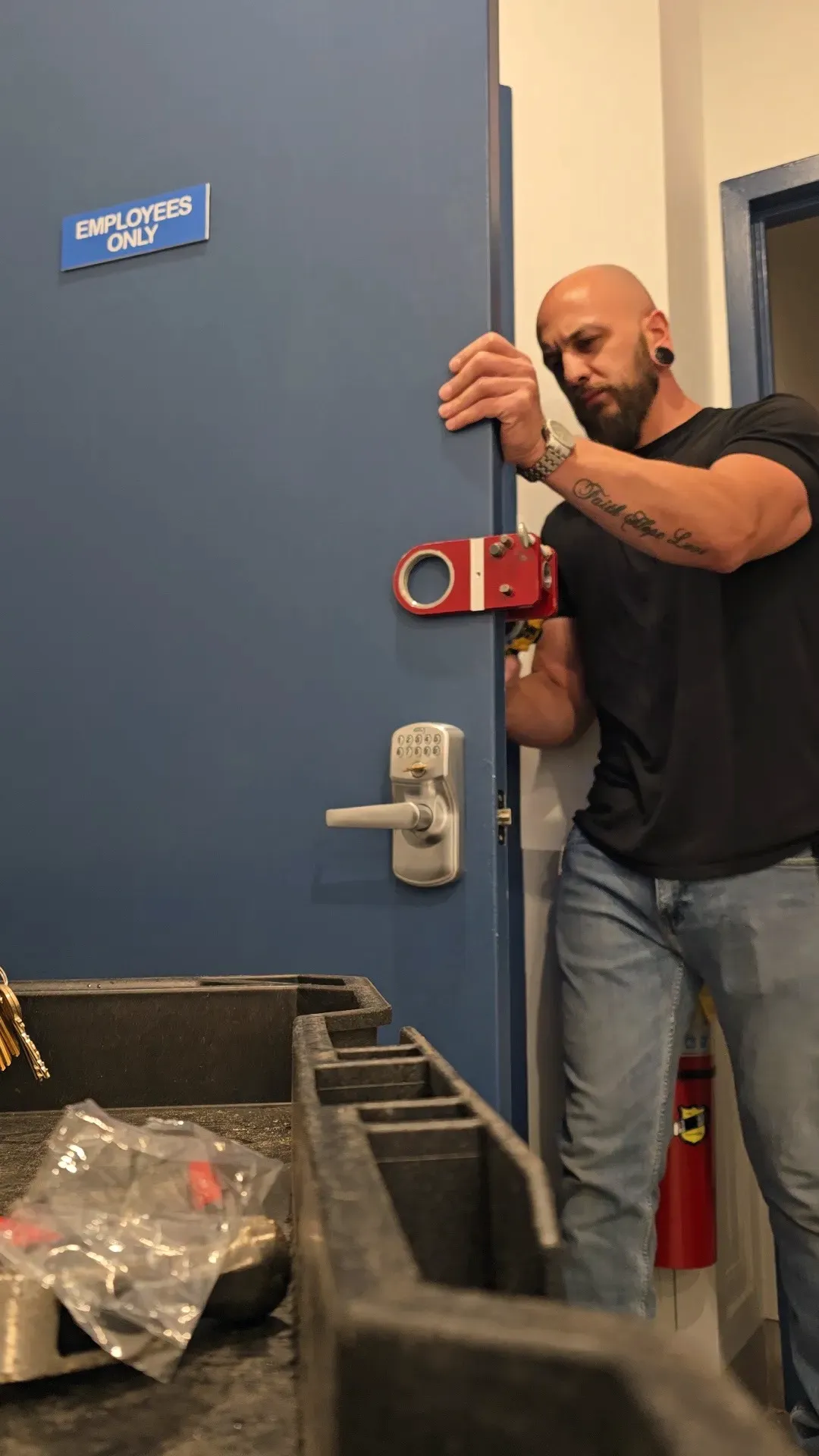 Christopher fitting a boring jig to a commercial door for new lock hardware