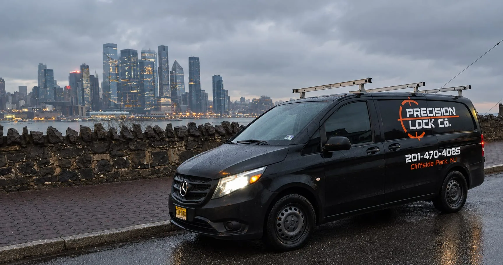 Precision Lock Co. van parked above the Hudson River with the Manhattan skyline behind it